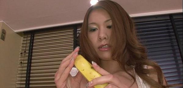  Hot and sexy redhead playing with a hard banana in the kitchen
